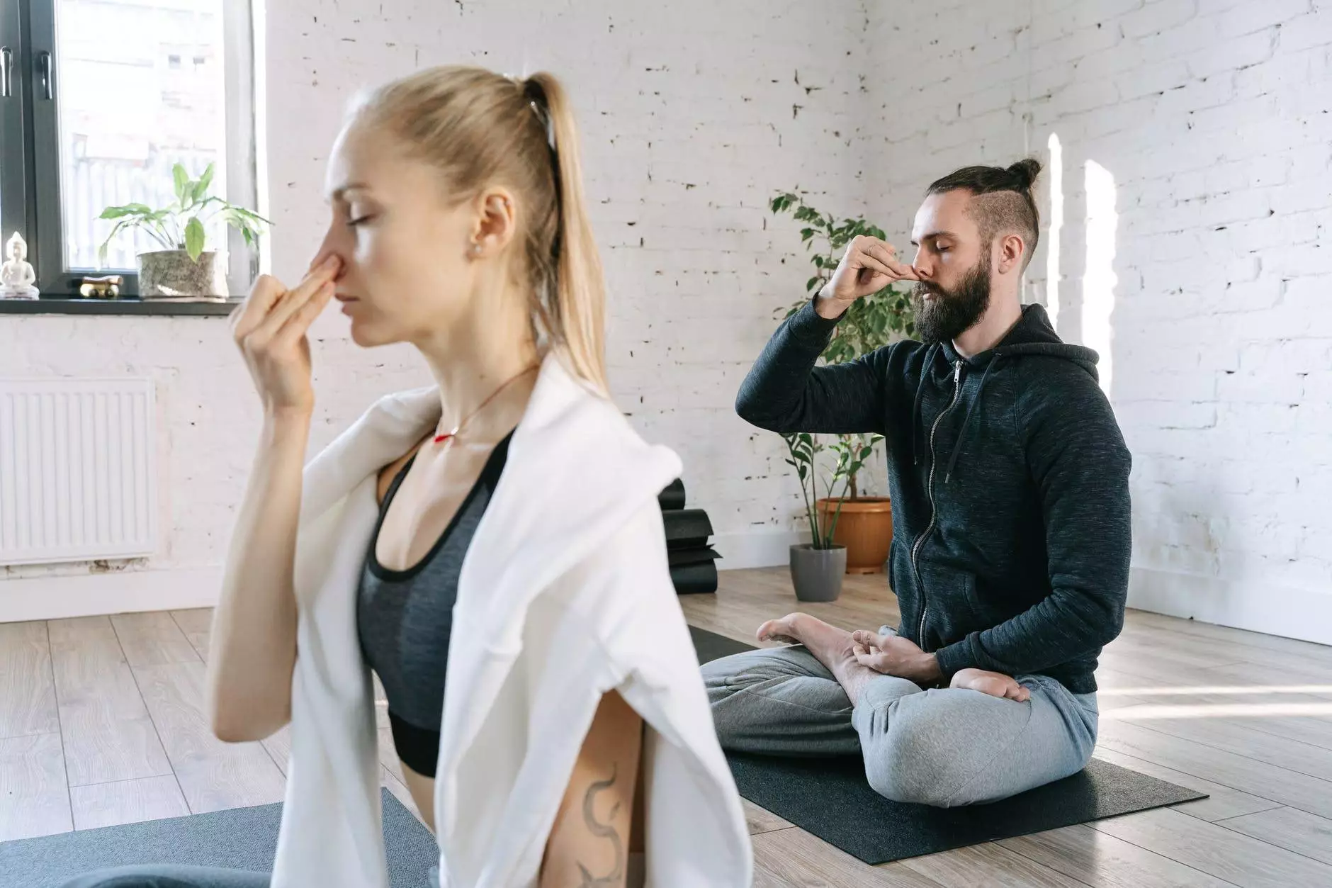 a man and a woman doing yoga